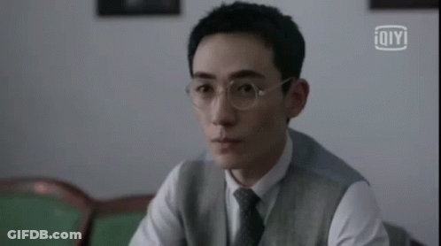 Man Wearing Glasses And Vest Sitting GIF