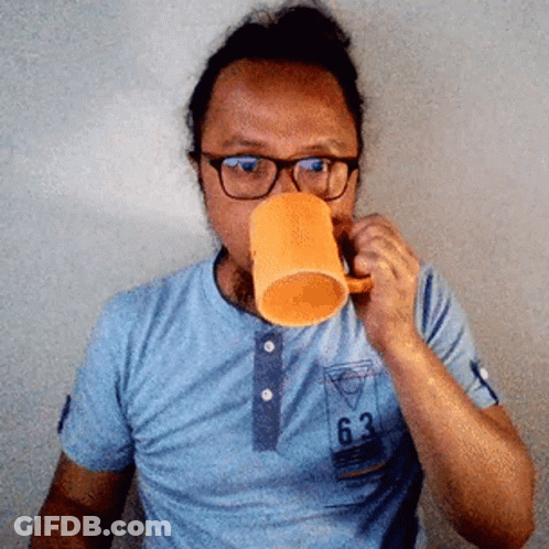 Man Wearing Glasses Drinking From Orange Cup GIF