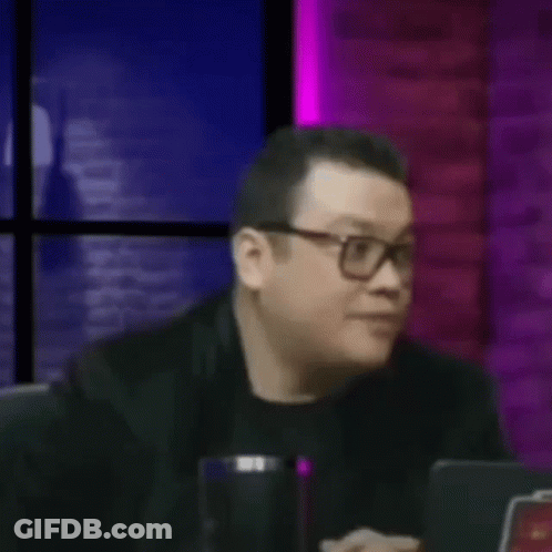 Man Wearing Glasses Hands On Face At Table GIF