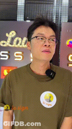 Man Wearing Glasses In Front Of Lou Sign GIF