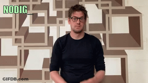 Man Wearing Glasses In Front Of NODIG Wall GIF