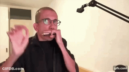 Man Wearing Glasses Playing Harmonica GIF