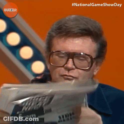 Man Wearing Glasses Reading Newspaper With Buzzr Logo GIF