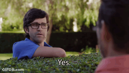 Man Wearing Glasses Says Yes While Sitting In Bush GIF