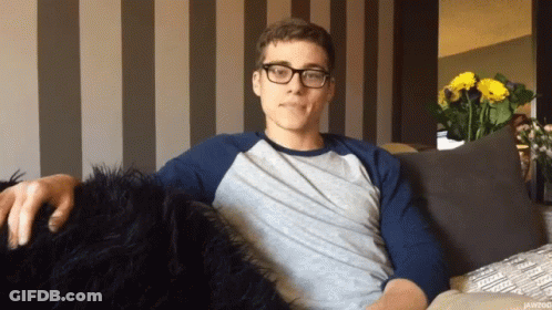 Man Wearing Glasses Sitting On Couch GIF