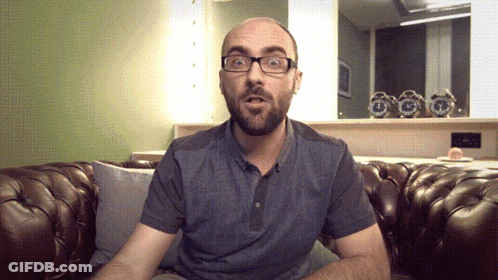 Man Wearing Glasses Sitting On Couch GIF