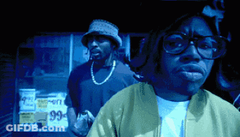 Man Wearing Glasses Stands In Front Of 99 Cents Sign GIF
