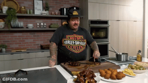 Man Wearing Harley Davidson T-Shirt Cutting Meat GIF