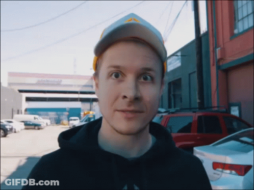 Man Wearing Hat And Black Hoodie In Front Of Abercrombie Building GIF