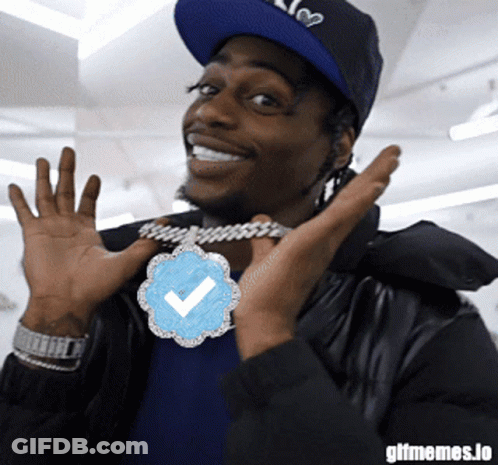 Man Wearing Hat And Check Mark Necklace GIF