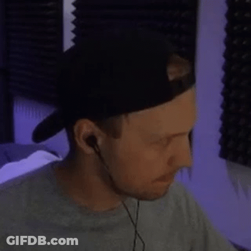 Man Wearing Hat And Earbuds Looking Down GIF