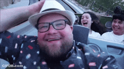 Man Wearing Hat And Glasses Smiling On Roller Coaster GIF