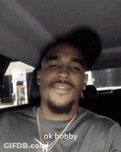 Man Wearing Hat And Necklace Says Ok Bobby GIF