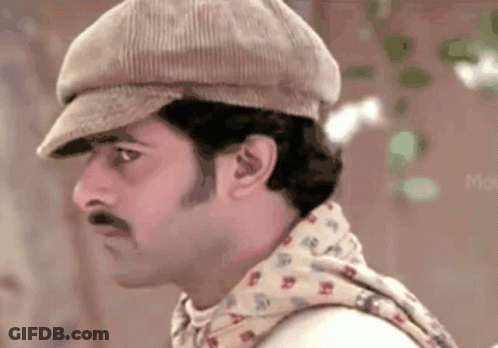 Man Wearing Hat And Scarf Looks Left GIF