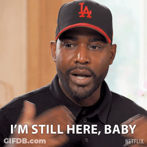 Man Wearing Hat Saying I'm Still Here Baby GIF