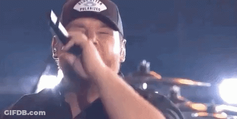 Man Wearing Hat Singing Into Microphone GIF