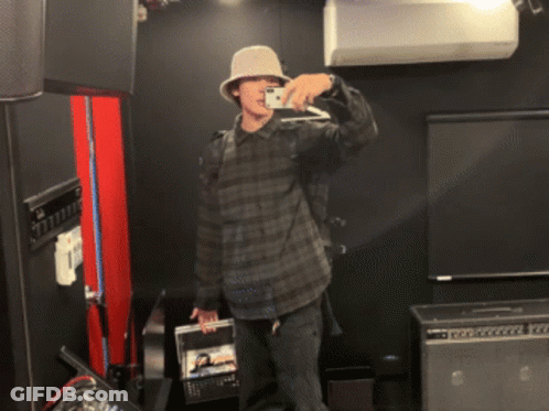 Man Wearing Hat Takes Picture Of Himself In Mirror GIF