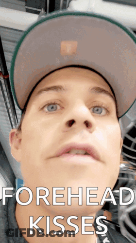 Man Wearing Hat With Forehead Kisses GIF