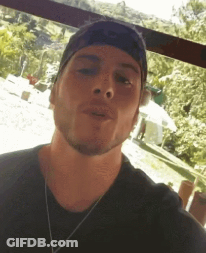 Man Wearing Headband And Black Shirt Talking To Camera GIF