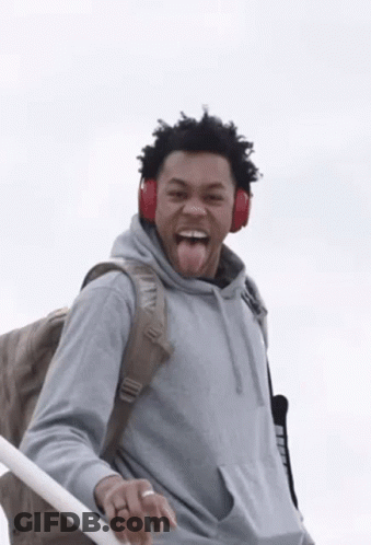 Man Wearing Headphones And Backpack Sticking Tongue Out GIF