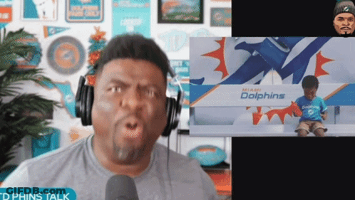 Man Wearing Headphones And Dolphins Shirt GIF