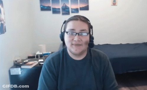 Man Wearing Headphones And Glasses Sitting In Room GIF