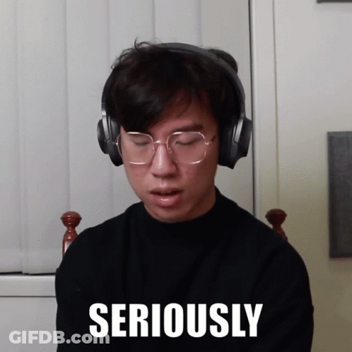 Man Wearing Headphones And Glasses With Seriously On Face GIF