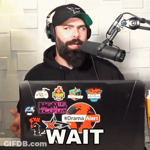 Man Wearing Headphones And Hat Behind Laptop Wait GIF