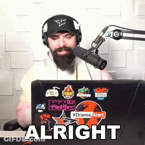 Man Wearing Headphones And Hat Sitting In Front Of Laptop Saying Alright GIF
