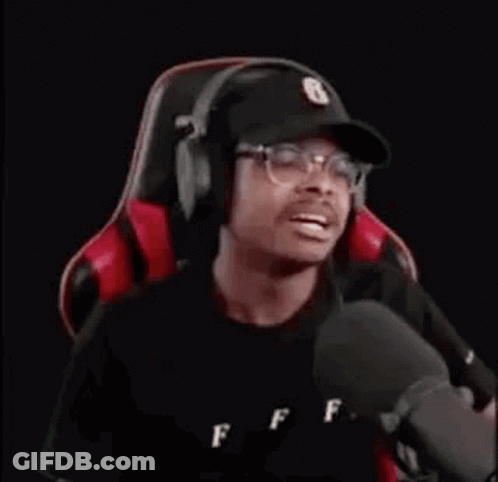 Man Wearing Headphones And Hat Sitting In Gaming Chair GIF