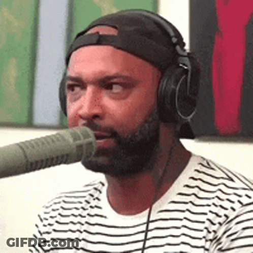 Man Wearing Headphones And Hat Talking Into Microphone GIF