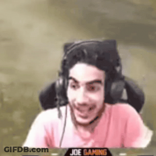Man Wearing Headphones And Pink Shirt Sitting And Smiling GIF