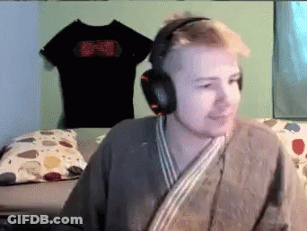Man Wearing Headphones And Robe Sitting In Bedroom GIF