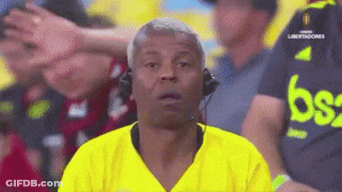Man Wearing Headphones And Yellow Shirt With Letter B GIF