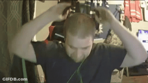 Man Wearing Headphones Holding Head GIF