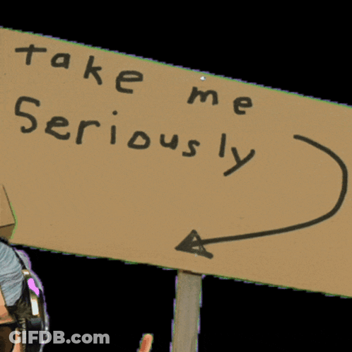 Man Wearing Headphones Holding Take Me Seriously Sign GIF