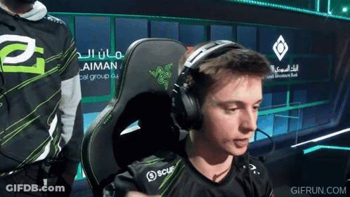Man Wearing Headphones In Front Of Aiman Sign GIF