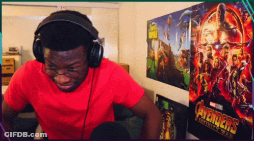 Man Wearing Headphones In Front Of Avengers Infinity War Poster GIF
