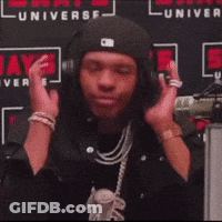Man Wearing Headphones In Front Of Universe Wall GIF