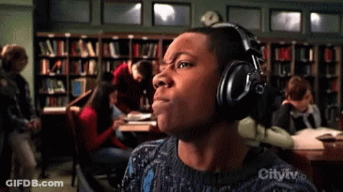 Man Wearing Headphones In Library With City TV Logo GIF