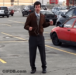 Man Wearing Headphones In Parking Lot GIF