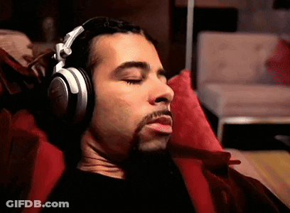 Man Wearing Headphones Laying On Couch GIF