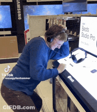 Man Wearing Headphones Looking At Beats Studio Pro Display GIF