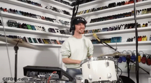 Man Wearing Headphones Playing Drum Set GIF