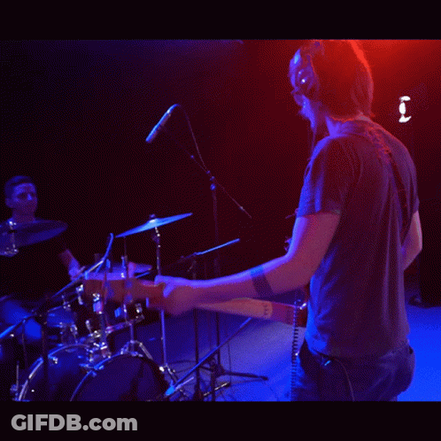 Man Wearing Headphones Playing Guitar On Stage GIF