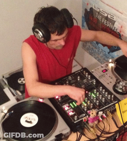 Man Wearing Headphones Playing Record In Front Of USB Festival Poster GIF