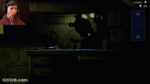 Man Wearing Headphones Playing Video Game At Night GIF