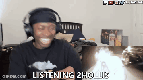 Man Wearing Headphones Says Listening 2 Hollis In Front Of Fire GIF