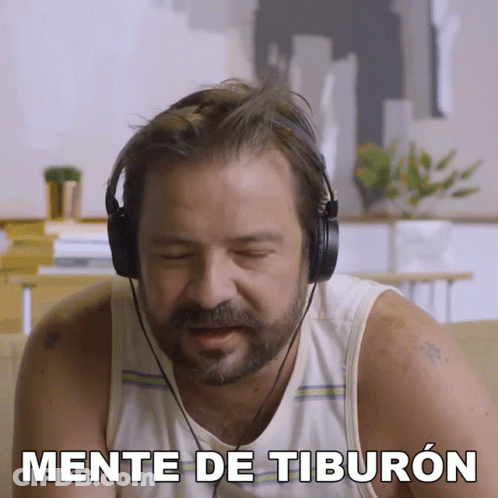 Man Wearing Headphones Says Mente De Tiburon On Screen GIF