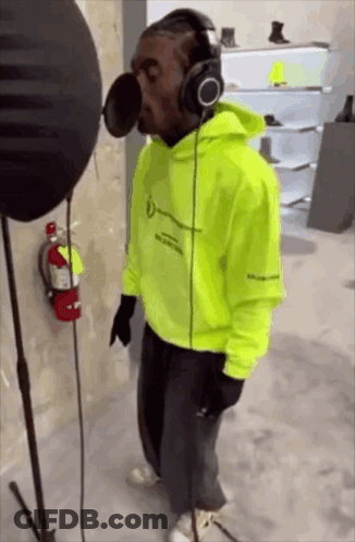 Man Wearing Headphones Singing Into Microphone GIF